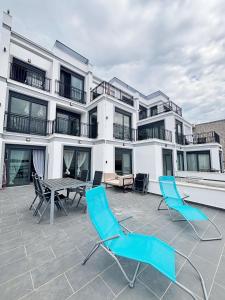 a patio with chairs and a table and a building at Modern Garden House in Tivat
