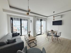 a living room with a couch and a table at Modern Garden House in Tivat