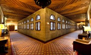 a large room with windows and a tiled floor at Parador de Santiago - Hostal Reis Catolicos in Santiago de Compostela