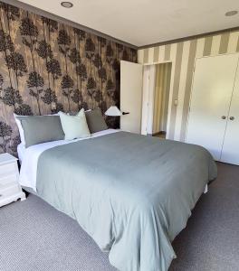 a bedroom with a large bed in a room at Miro St Guest House in Mount Maunganui