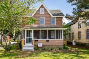 a brown house with a tree in front of it at The Mane Escape in Chincoteague
