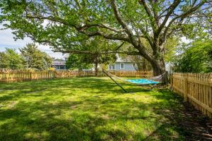 a hammock under a tree in a yard at The Mane Escape in Chincoteague