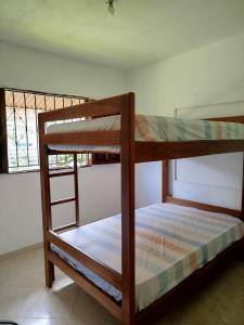 a couple of bunk beds in a room at Milflora casa completa in Nuquí