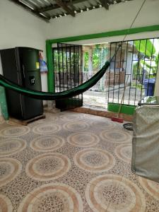an empty room with a hammock on the floor at Milflora casa completa in Nuquí +1 photo