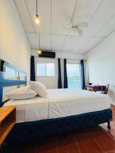 a bedroom with a large bed in a room at Maple Guest House in Flores