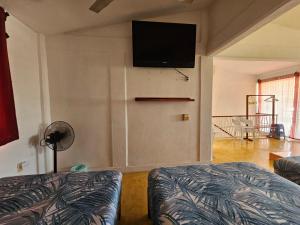 a living room with a flat screen tv on the wall at Departamento El Dorado in Barrio Nuevo +10 photos