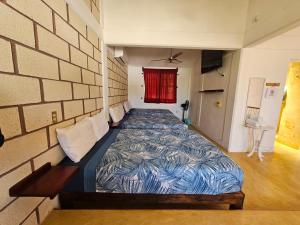 a bedroom with a bed in a brick wall at Departamento El Dorado in Barrio Nuevo
