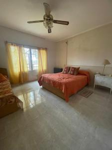 a bedroom with a bed and a ceiling fan at Doñalola in General Alvear