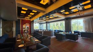 a restaurant with couches and tables in a room at Hotel skyline by RK in Tinsukia
