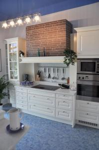 a kitchen with white appliances and a brick wall at Business Home Vienna in Vienna