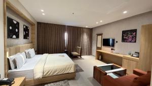 a hotel room with a bed and a couch at Hotel skyline by RK in Tinsukia