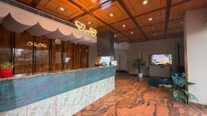 a lobby with a bar in a building at Hotel skyline by RK in Tinsukia
