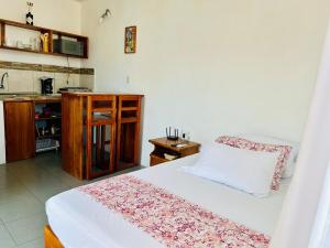 a bedroom with a bed and a table and a kitchen at SUITE5 ROMANTICA TERRAZA Y VISTa in Huamboya