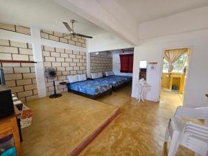 a room with a bed and a couch in it at Departamento El Dorado in Barrio Nuevo