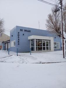 a store front of a building in the snow at Hosteria Posada Drake in Puerto San Julián +4 photos