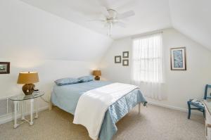 a bedroom with a bed and a ceiling fan at The Sweets Spot in Greenbackville