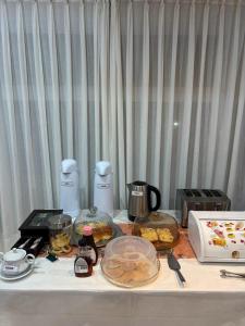 a table with some food and appliances on it at Hosteria Posada Drake in Puerto San Julián