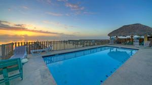 a swimming pool with a view of the ocean at Laguna Sunset by AvantStay in Corpus Christi