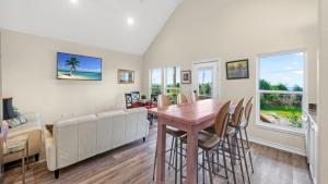 a living room with a table and a couch at Laguna Sunset by AvantStay in Corpus Christi