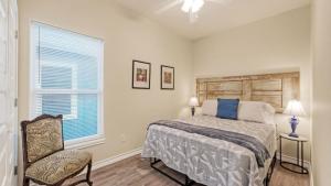 a bedroom with a bed and a chair and a window at Laguna Sunset by AvantStay in Corpus Christi +42 photos