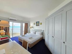 a hotel room with a bed and a balcony at Paradise by the Sea in Penang by Veron at Rainbow Paradise in Tanjung Bungah +185 photos