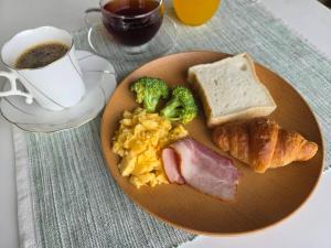 a plate of breakfast food with eggs bacon broccoli and toast at Hotel Xenia Takinoyashiro in Kato