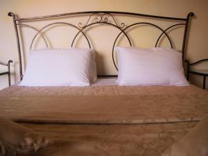 a bed with two white pillows on it at Casa Alice in Rovinj