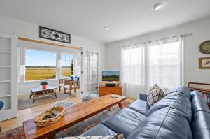 a living room with a couch and a table at To the Lighthouse in Birch Town