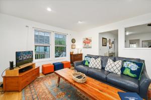a living room with a couch and a tv at To the Lighthouse in Birch Town +39 photos