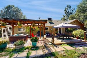 a backyard with a pergola and a house at 1 Mi to Lake Tulloch: Home w/ Patio Oasis & Pool in Copper Cove Subdivision