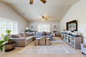 a living room with a couch and a tv at 1 Mi to Lake Tulloch: Home w/ Patio Oasis & Pool in Copper Cove Subdivision