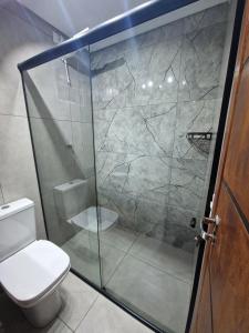 a bathroom with a shower and a toilet at Condomínio Inn Studio in Foz do Iguaçu