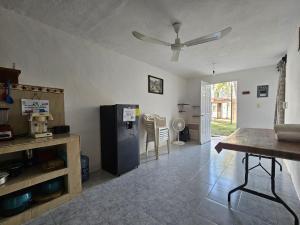 a living room with a black refrigerator and a table at Departamento en la Huertas in Barrio Nuevo