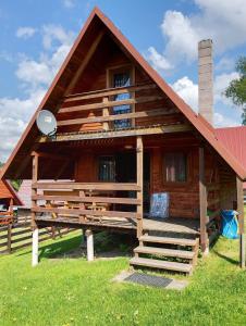 a large wooden house with a red roof at Domek Olchowiec 2 Nad Soliną in Olchowiec