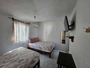 a small room with two beds and a window at Departamento en la Huertas in Barrio Nuevo +29 photos