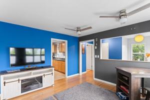 a living room with blue walls and a flat screen tv at Close To Airport - Shared Space - Fast WI-FI in Anchorage