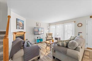 a living room with two couches and a fireplace at Whispering Pines in Black Point Landing