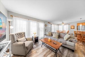 a living room with a couch and a table at Whispering Pines in Black Point Landing