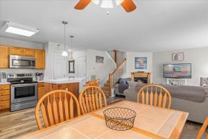 a kitchen and living room with a table and a couch at Whispering Pines in Black Point Landing +38 photos