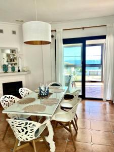 a white dining room with a table and chairs at Chalet Playa Mazagon in Mazagón +20 photos