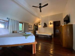 a bedroom with a bed and a ceiling fan at Happiness Boutique Resort El Nido in El Nido