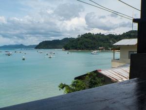 a view of a body of water with boats in it at Happiness Hostel El Nido in El Nido