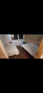 a bedroom with two beds and a window at Entre Bosque Puelo in Puelo