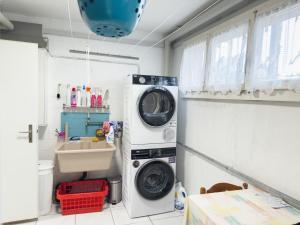 a laundry room with a washing machine and a sink at Einfamilienhaus in Amriswil in Amriswil