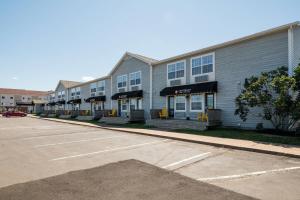 a row of buildings in a parking lot at Amsterdam Inn & Suites, an Ascend Collection Hotel in Moncton