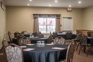a conference room with tables and chairs and a window at Amsterdam Inn & Suites, an Ascend Collection Hotel in Moncton