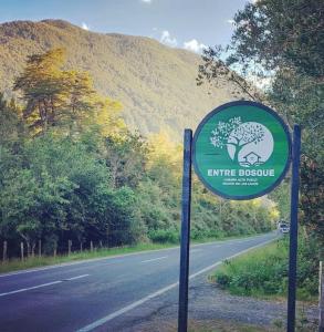 a sign on the side of a road at Entre Bosque Puelo in Puelo