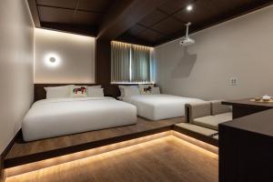 a bedroom with two beds and a couch at Onjae Stay Seongsu in Seoul +83 photos