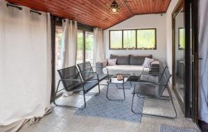 a screened in porch with a couch and chairs at Awesome Home In Karlovac in Karlovac