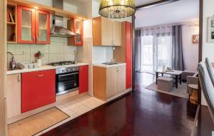 a kitchen with red cabinets and a dining room at Awesome Home In Karlovac in Karlovac